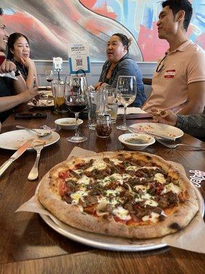 Enjoying our Brisket Pizza at Pizzeria Mercato in the Public Market in Emeryville.