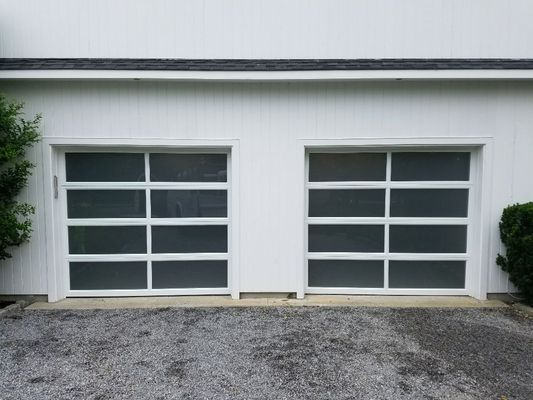 Another, Modern Aluminum Garage Door with tinted windows installed by Above & Beyond Garage Doors in Hampton Bays. Complete w/ new hardware.