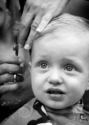 The bebe's first haircut. Watery eyes, not crying. Promise. :)