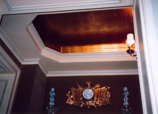 Metallic gold leaf paper installed in recessed ceiling.