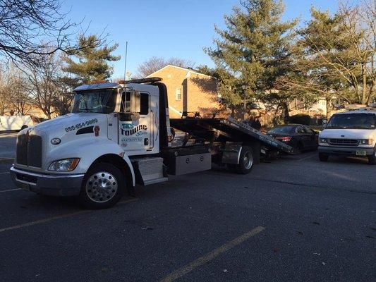 TK's towing services using our flat bed tow truck to wench up a honda accord with no front wheels. (we do magic)