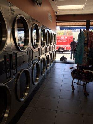 Large row of dryers with the am ambulance in the background.