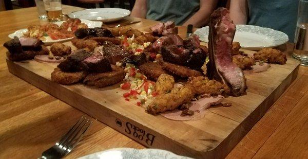 This is the picture of one course of steak, roasted meats, fried green tomatoes and liver pate.