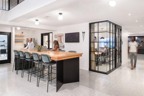 Our shared kitchen, dining area, and one of our meeting rooms. The dining table top is from the original boardroom of the building.