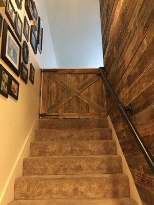 Tim custom built a child gate at the top of our stairs to match the custom wood plank wall he built.