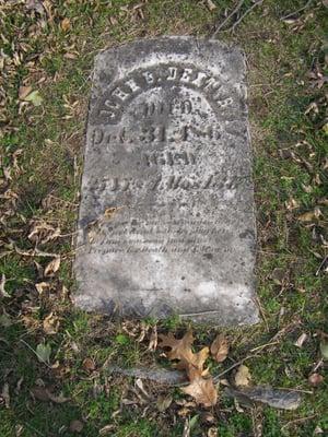 Personal pic- a flat headstone with a barely readable inscription.