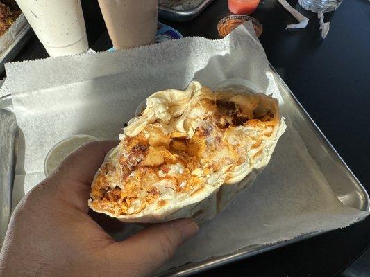 Dorito burrito totally stuff with dorito breaded chicken, cheese, fries, and ranch dressing on the side.