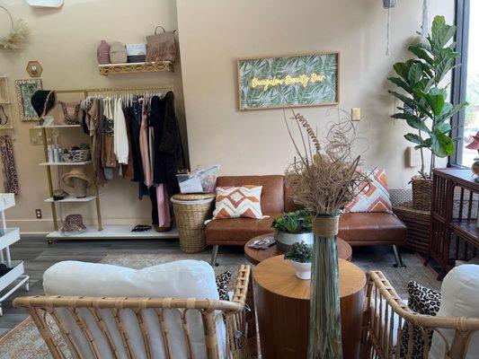 Waiting area and boutique wall with cute clothes and accessories for sale