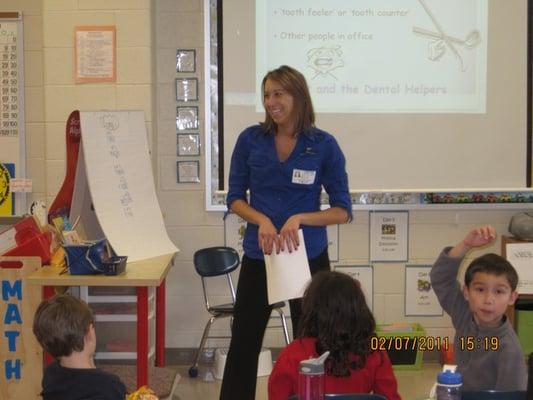 Some of community work. Mia speaking at a local school.