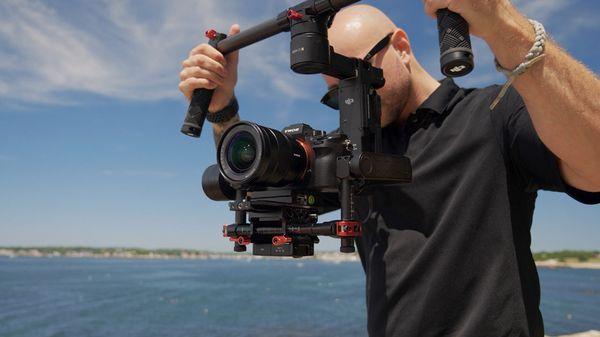 A behind the scenes shot of Luxe Life Owner, Matt, shooting an amazing waterfront property!