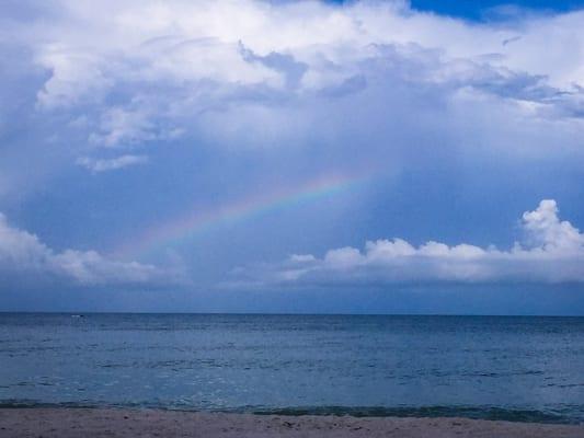 Enjoying the sand, sun, surf, and a beautiful rainbow this morning!