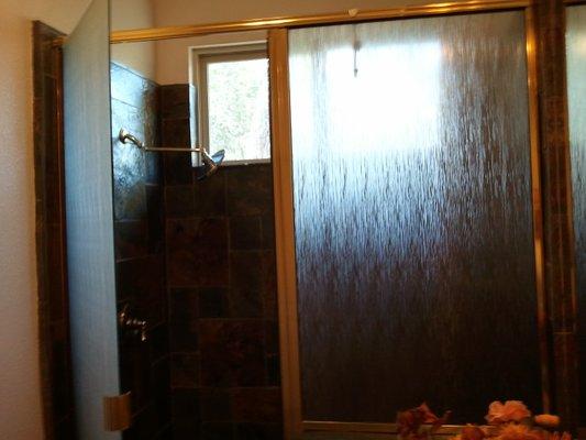 Hard water had permanently stained this shower glass.  Decorative film has a much better look.