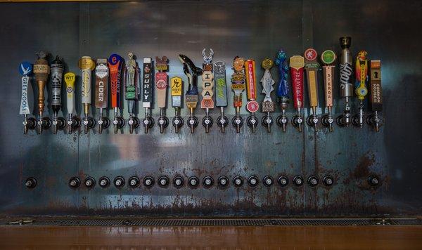 A lineup of our primary product category, tap handles, on bar tap faucets.