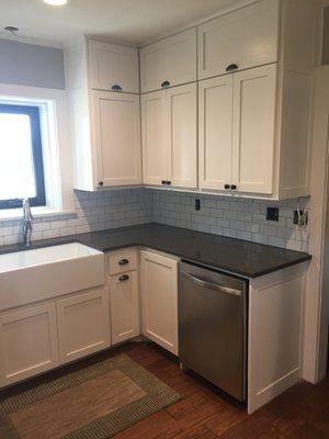 custom built white farm house shaker style cabinet. quartz counter top