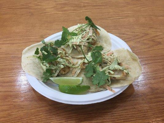 Habanero chicken tacos with fresh greens and lime.