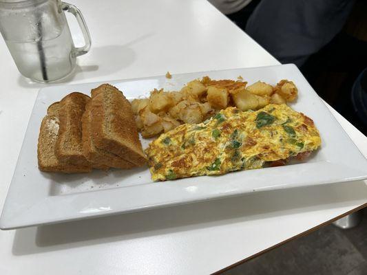 Vegetable omelet with wheat toast and home fries