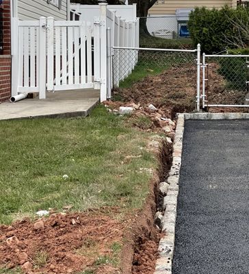 Look at the gap between grass and belgian blocks. They just left it like that. You can also see my neighbor's broken fence.