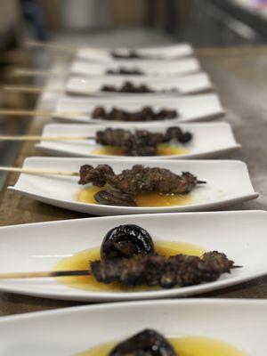 Tuscan meet skewer with braised mushrooms and clarified butter