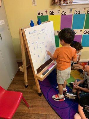 Son practicing letter recognition of English and Spanish Word