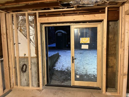 our garage conversion into a gym , bedroom & bathroom with new Marvin French doors installed