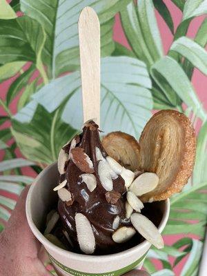 Chocolate Nior! Dark Chocolate FroYo topped with caramel sauce, sliced almonds and a palmier cookie.