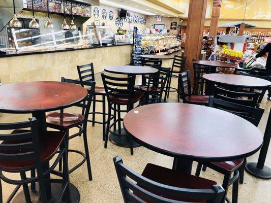 Seating area for the lunch counter kept clean and tidy. Polished wood furniture arranged so everyone has room.