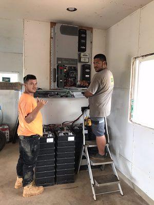 Robert and Kaipo installing one 8kw Radian with 7 Aquion batteries powered by 15 Canadian Solar 280watt panels. Off Grid! All good!