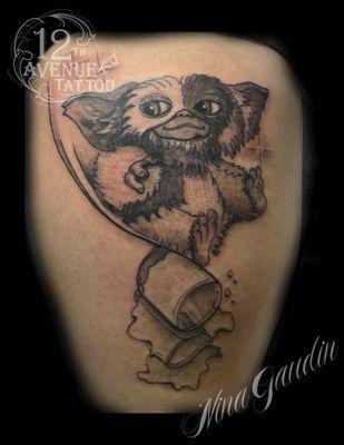 Gizmo black arm tattoo by Nina Gaudin of 12th Avenue Tattoo in Nampa, Idaho!