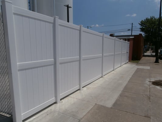 Eight foot white privacy fencing.