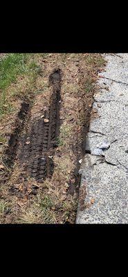 Tire marks and cracked cement damages left behind from their tow truck.