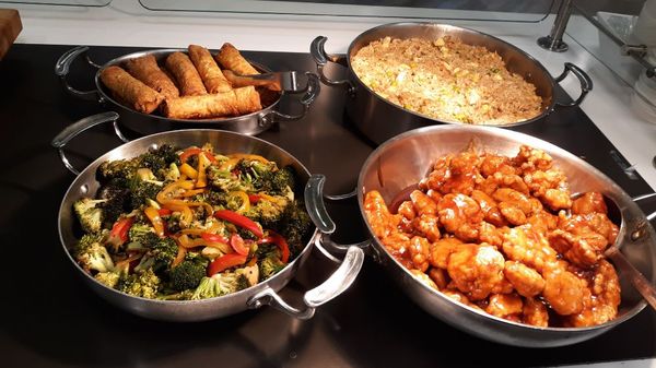 Stir fry veggies, sesame chicken, egg rolls and stir fry rice