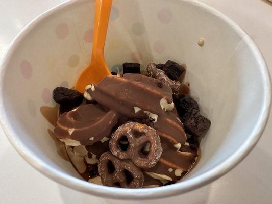 Peanut butter yogurt with hard shell chocolate sauce, brownie bits and chocolate covered pretzels