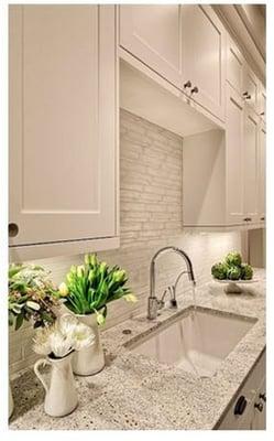 Granite countertop and marble backsplash