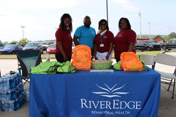 Some of our Child & Adolescent staff pose at the River Edge table at a Back-to-School event.