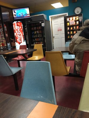 Plenty of seating with TV and vending machine.