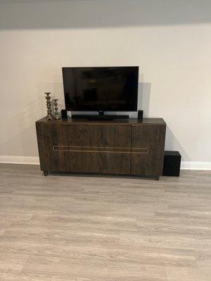 Wood TV stand with design going across 4 doors