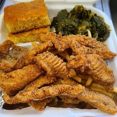 Catfish dinner with fries, greens and corn bread.