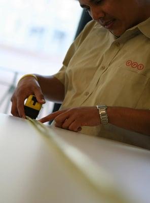 Field Project Manager measuring a work  surface.