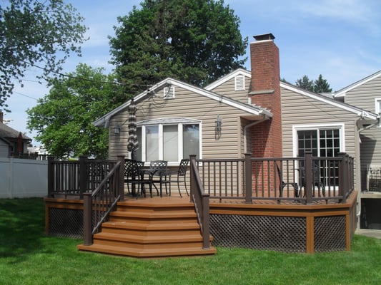 Custom deck designed by Deck Designs.  Low maintenance materials, vinyl lattice enclosure with angled stair...