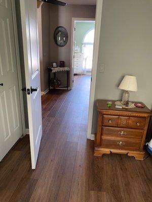 Laminate vinyl flooring in upstairs hallway and bedroom.