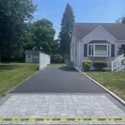 New asphalt driveway with paver apron