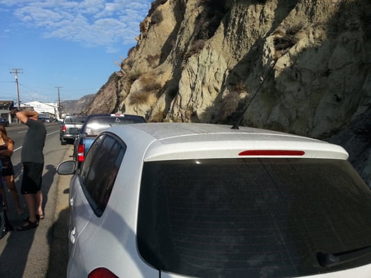 Parking on PCH across the street from the entrance.