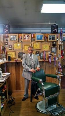 Champion Barber Pete Lira at his new shop with his many awards