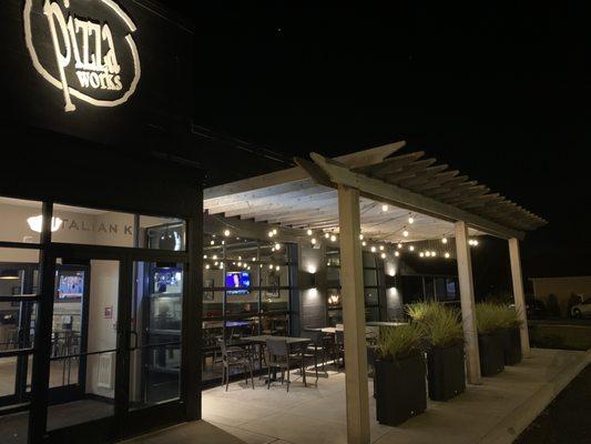 Entrance and outdoor seating with glass garage-type doors.