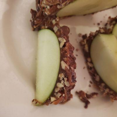 Close-up view of apple wedge. Look at those thick, decadent toppings!