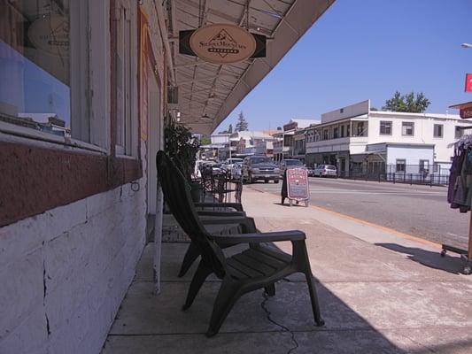 looking up the street past the chairs out front