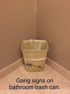 Gang signs on the trash can?