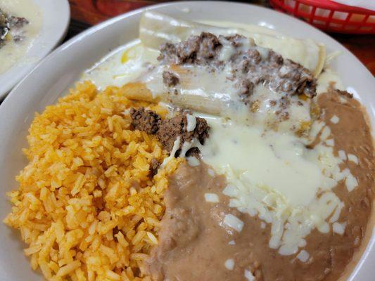 Burrito,  tamale,  rice and beans with cheese sauce.  This was part one entree with the taco, relleno and tostada.