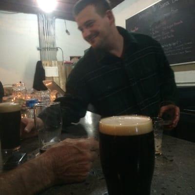 The inimitable owner of Bluetick Brewery: Mr. Christopher Snyder, standing near a Czarina Imperial Stout (IIRC).