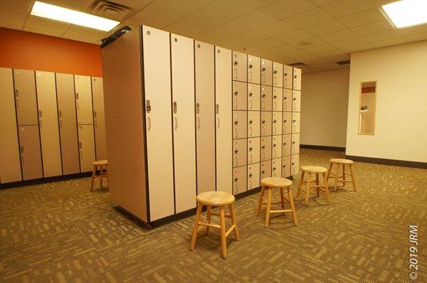 Large locker room with individual showers.